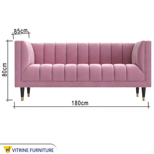 Rose color sofa with recessed lines on the back and base