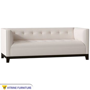 White sofa and black wooden legs