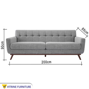 Gray sofa with slanted wooden legs