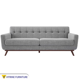 Gray sofa with slanted wooden legs