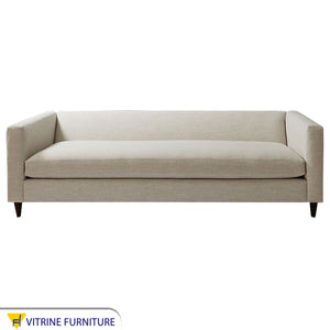Off white sofa with attached back and armrests