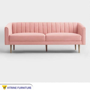 A pink parallelepiped capotone sofa