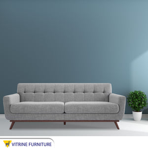 Gray sofa with slanted wooden legs