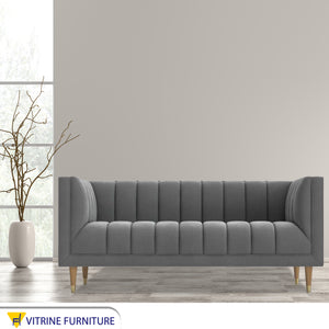 Gray sofa with recessed lines on the back and base