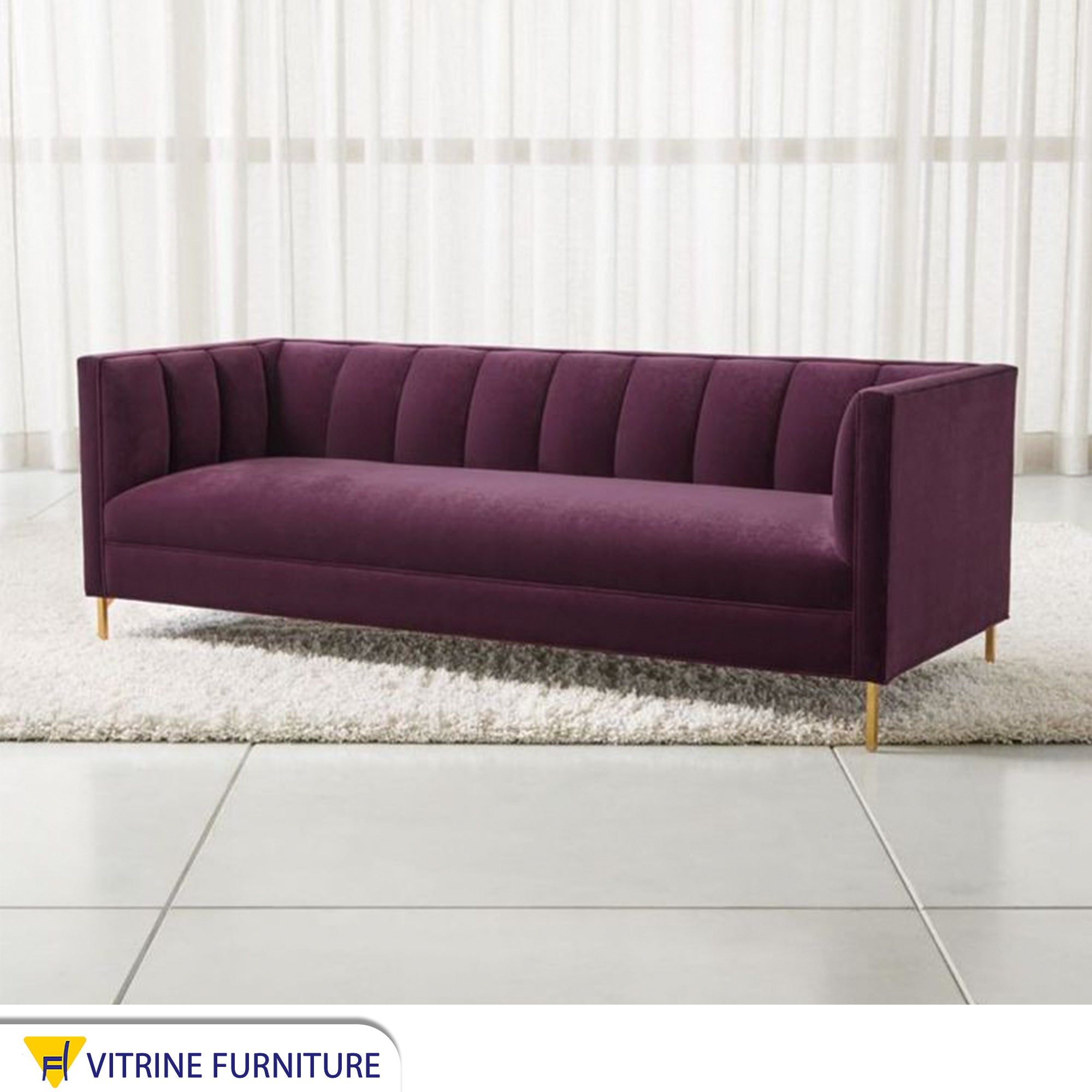 A burgundy sofa with successive recessed lines on the backrest