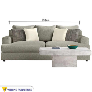 A grey sofa with a pair of base cushions