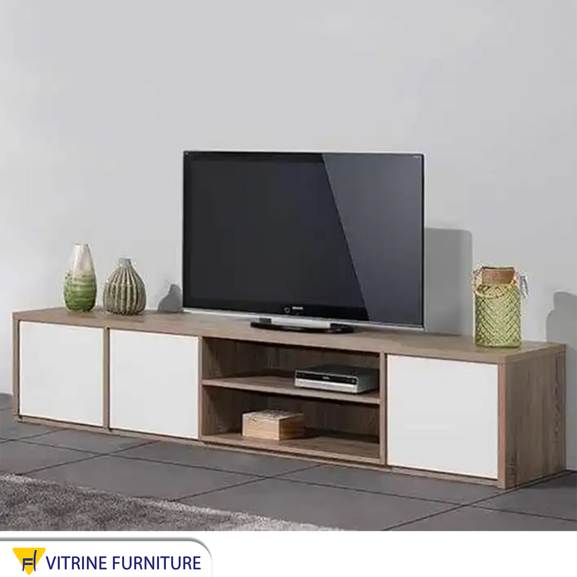 A TV table with two shelves and three doors