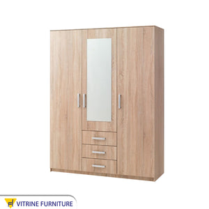 A beige wardrobe with three doors, including a mirrored door and three drawers