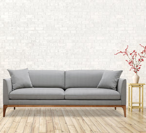 Gray sofa with high wooden legs