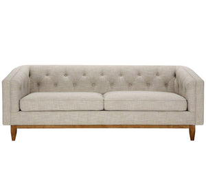 A beige sofa with capotonite grains, with armrests and backrest