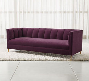 A burgundy sofa with successive recessed lines on the backrest