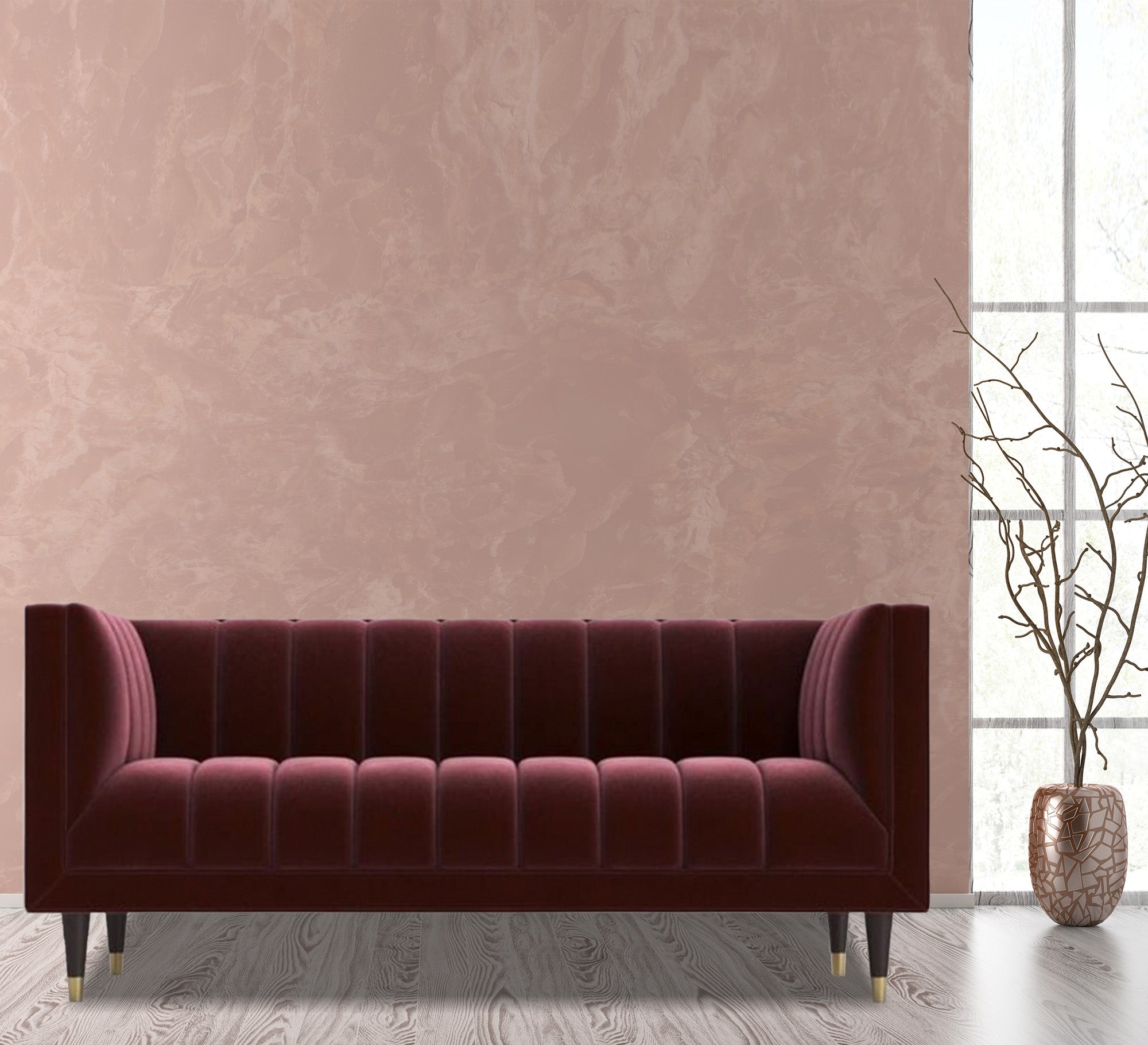 A sofa in a burgundy color with recessed lines on the back and the base