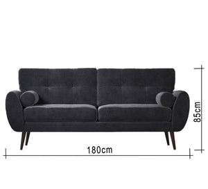 A high black sofa on elegant wooden legs