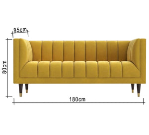 A sofa in a camel yellow color with recessed lines on the back and the base