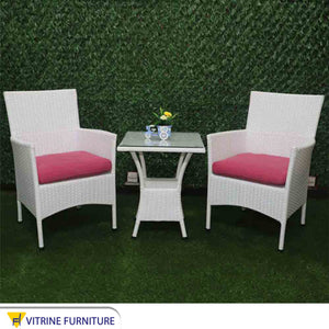 An outdoor seating set with a square table