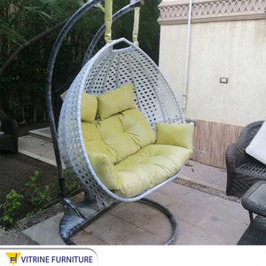 White and yellow swing chair for two people