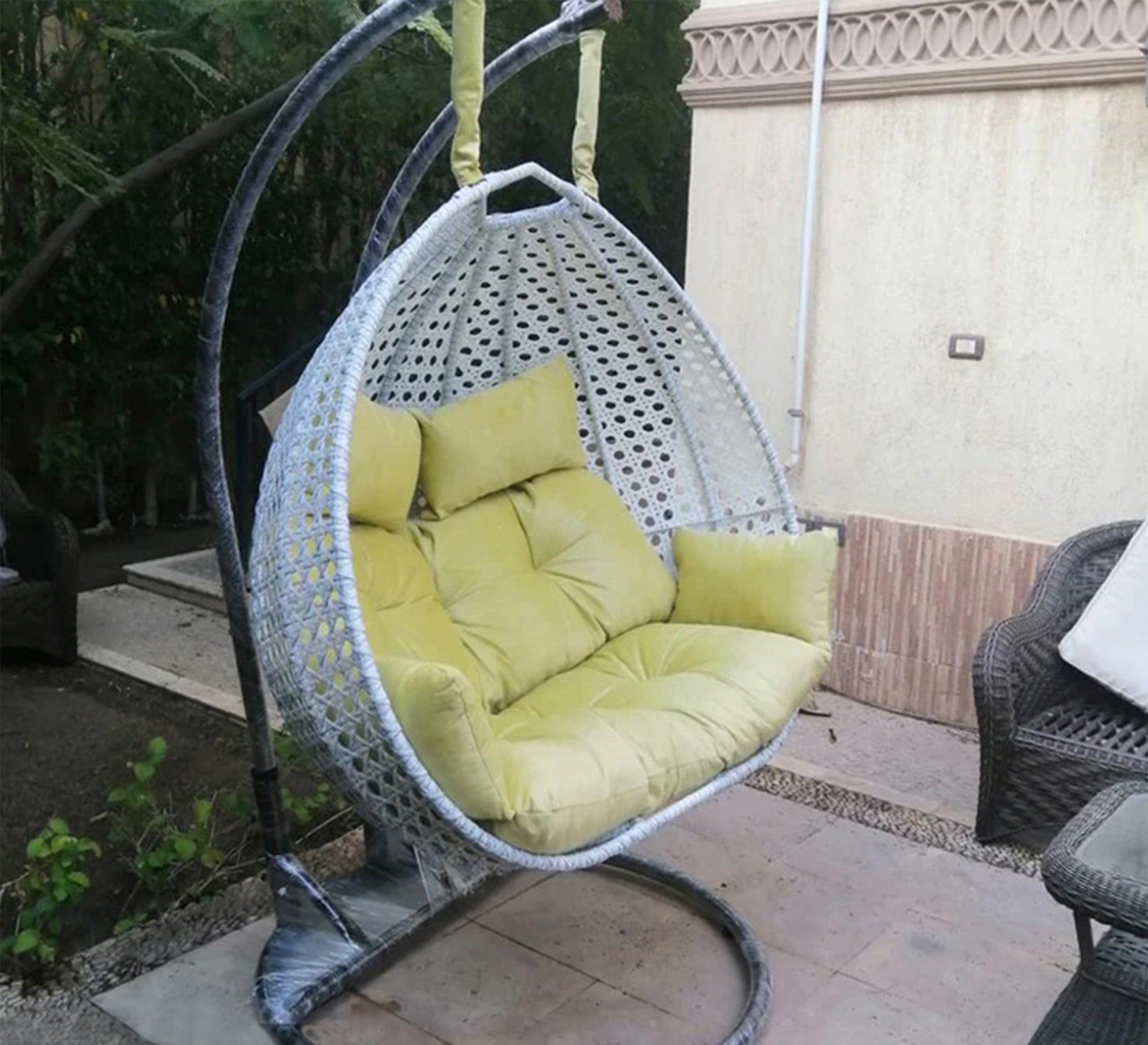 White and yellow swing chair for two people