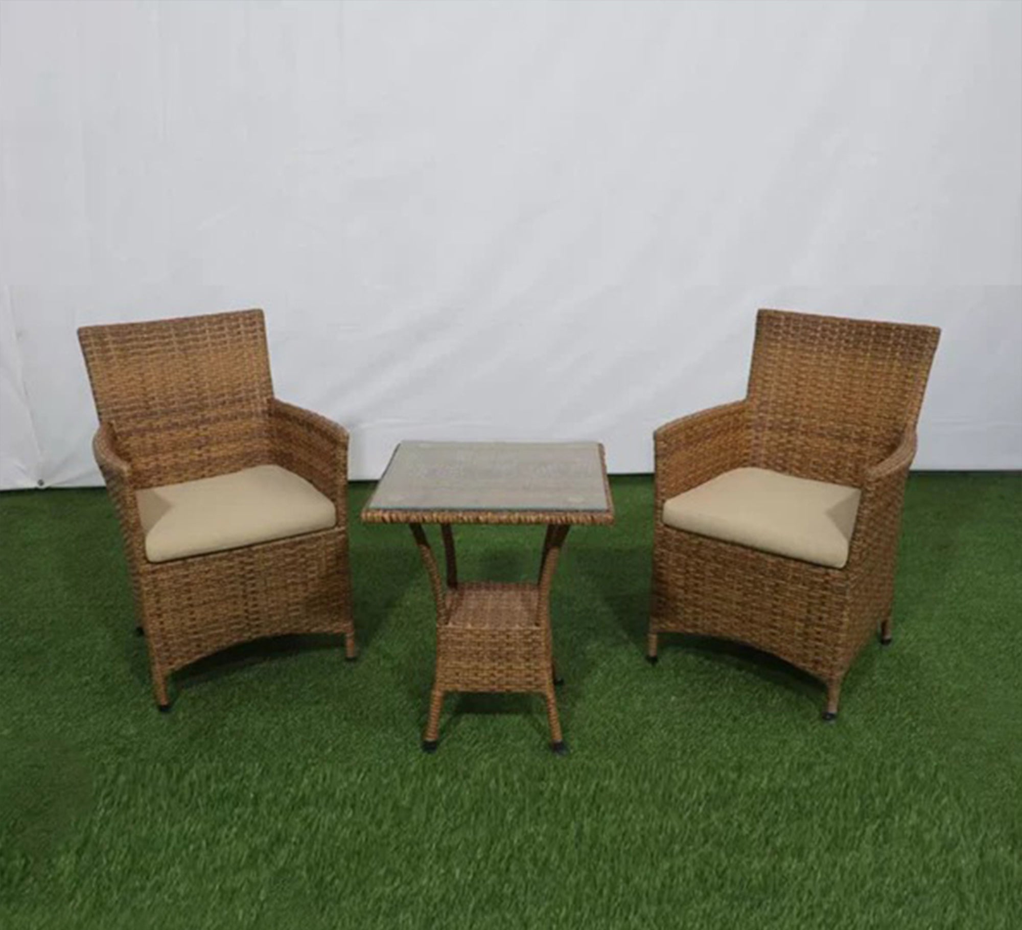 An outdoor set of 2 brown chairs and a table