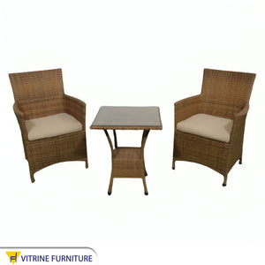 An outdoor set of 2 brown chairs and a table