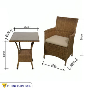 An outdoor set of 2 brown chairs and a table