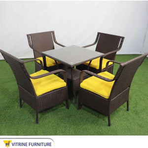 An outdoor set of 4 chairs and a table