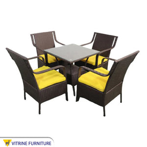 An outdoor set of 4 chairs and a table