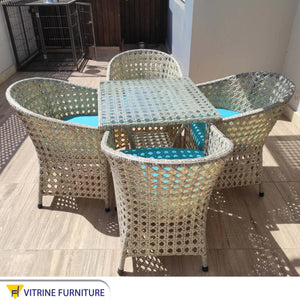 An outdoor set of 4 chairs and a table