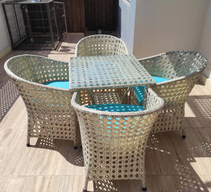 An outdoor set of 4 chairs and a table