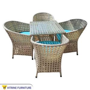 An outdoor set of 4 chairs and a table