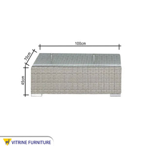 An outdoor set with a corner, a chair and two tables