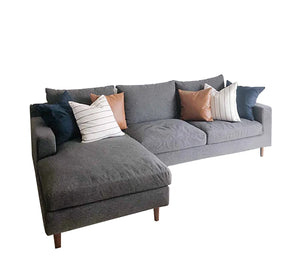 Light grey corner sofa with sturdy wooden legs