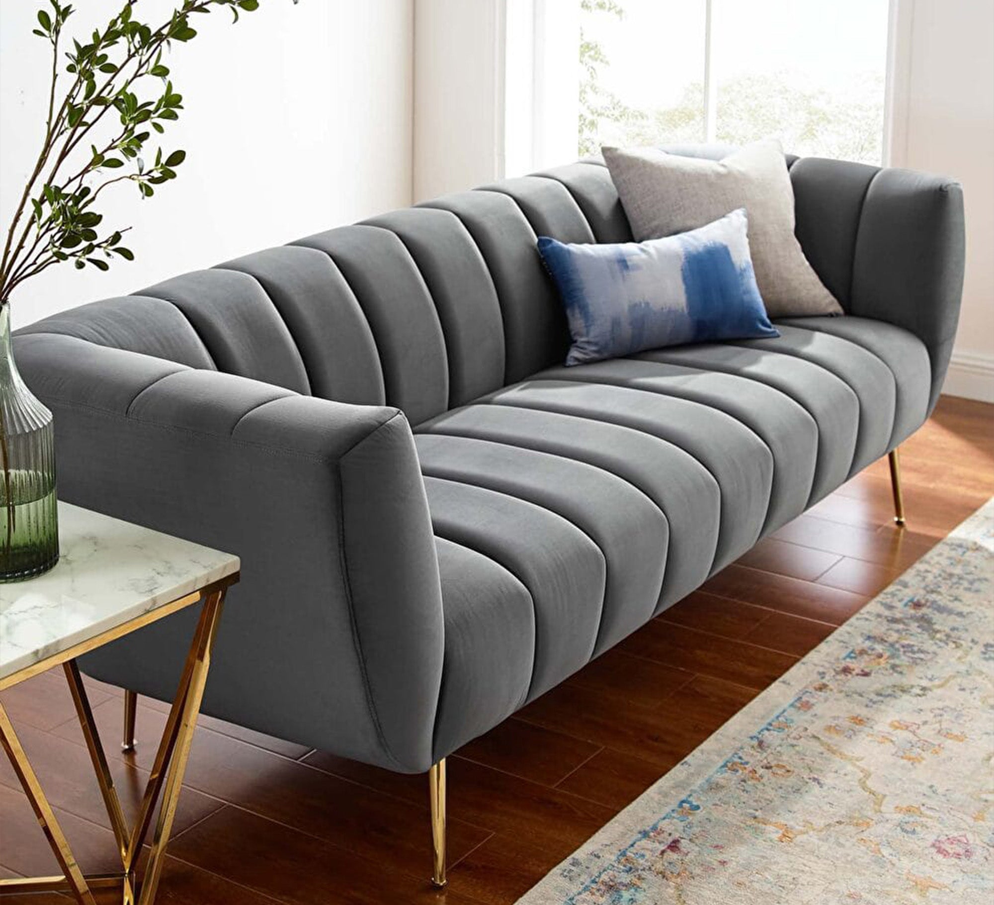 Modern light gray sofa with high legs