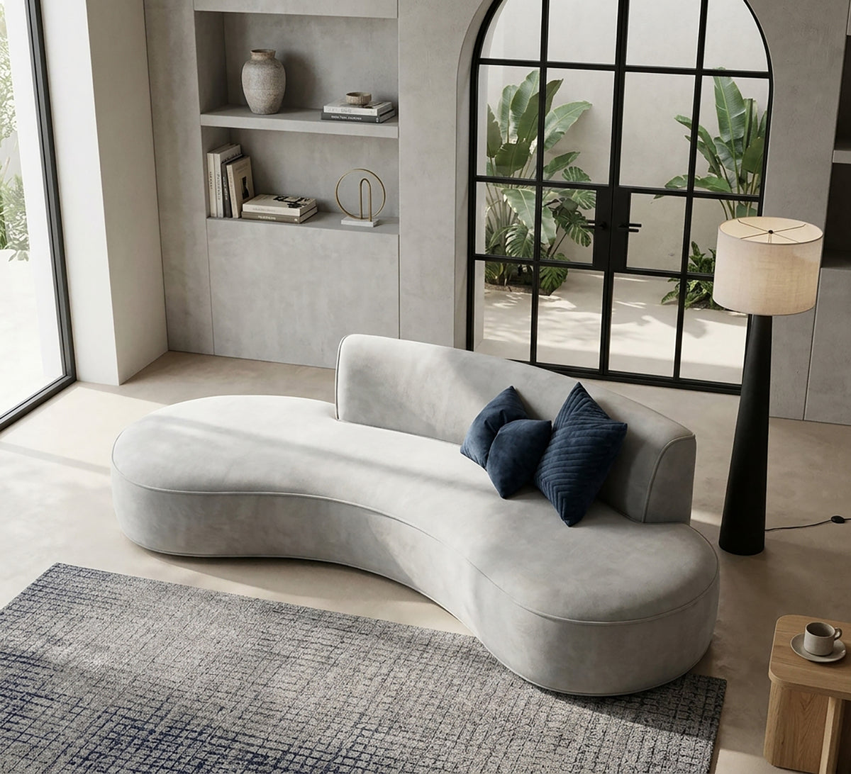 A modern curved sofa with comfortable cushions.