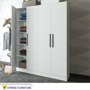 A white wardrobe with four moving doors