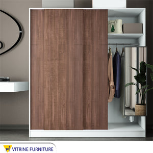 A three-leaf brown sliding wardrobe