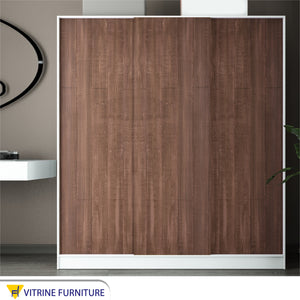 A three-leaf brown sliding wardrobe