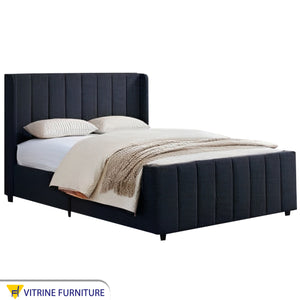 Black royal bed with upholstery divided lengthwise