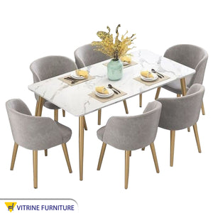 A rectangular dining table with six chairs
