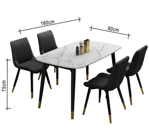 A white dining table and four black chairs