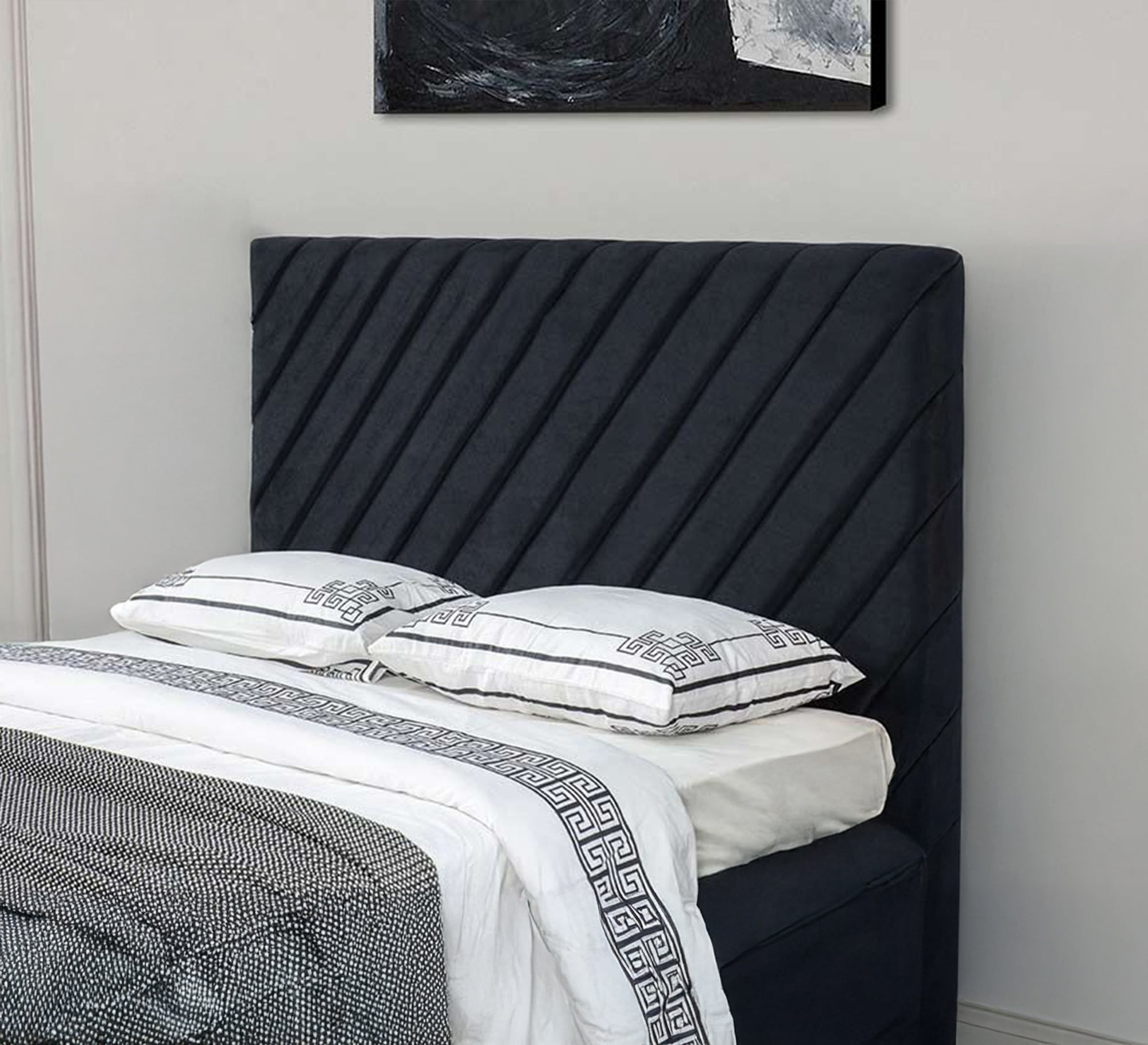Black bed with diagonal sunken lines