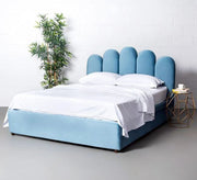 Blue bed with a comfortable design with vertical stripes
