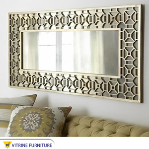 Mirror with a wide hollow wooden frame