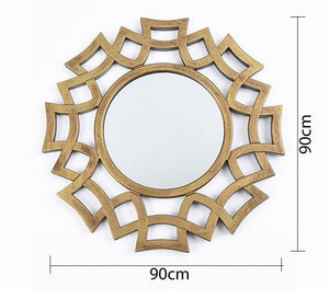 A circular mirror with a frame of hollow overlapping circles