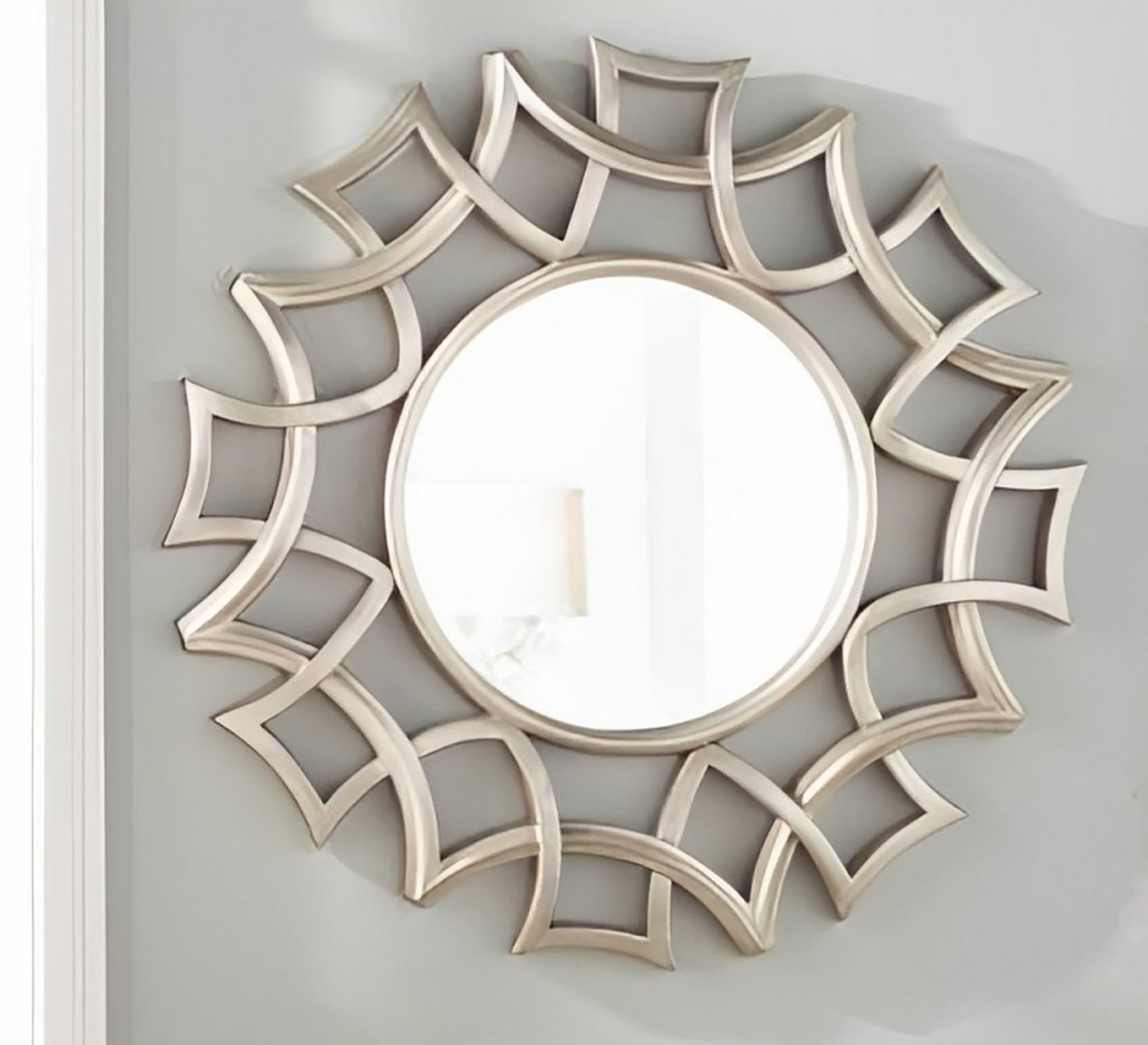 A circular mirror with a frame of hollow overlapping circles