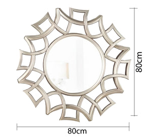 A circular mirror with a frame of hollow overlapping circles