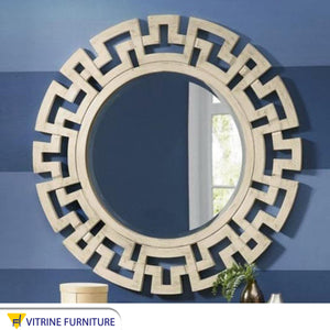 A circular mirror with a frame of hollow overlapping circles