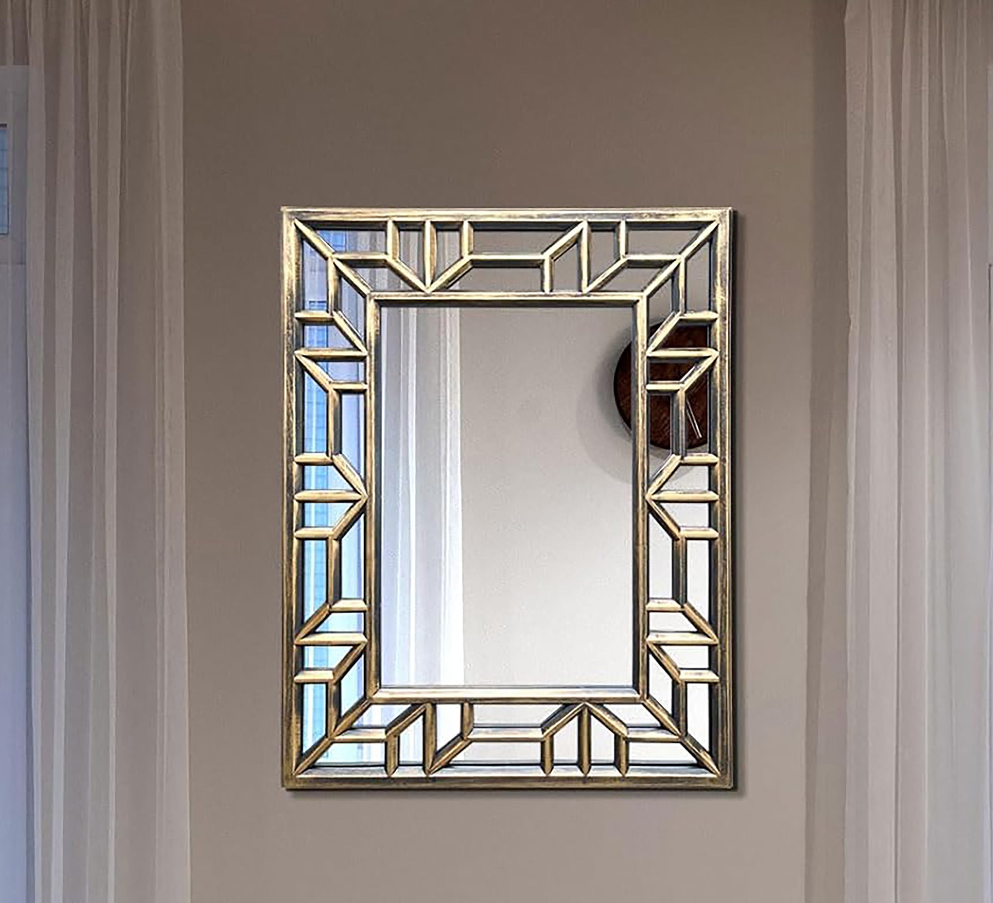 A rectangular mirror with two frames one of which is hollow wood