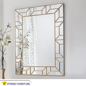 A rectangular mirror with two frames one of which is hollow wood