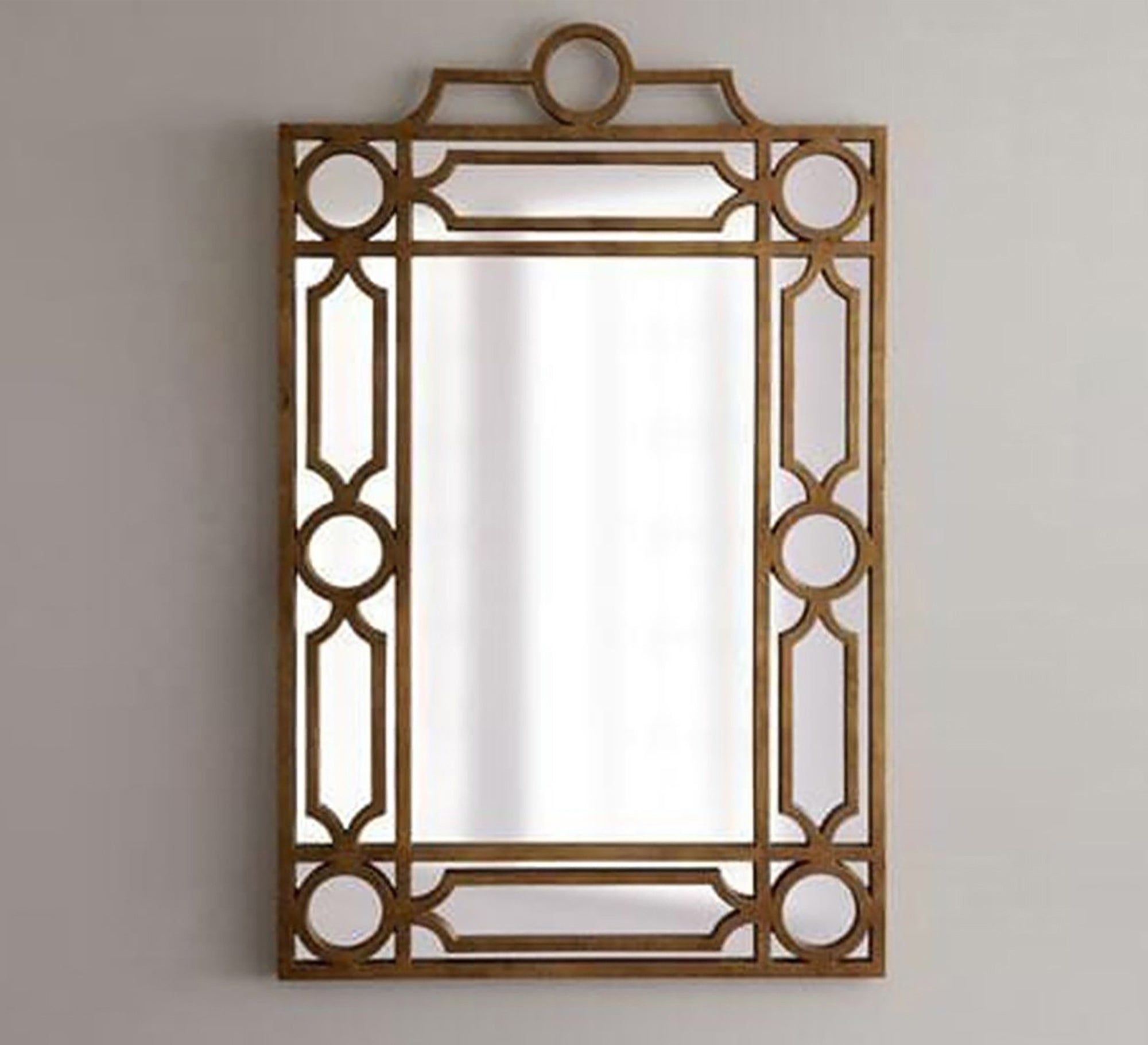 A rectangular mirror with a frame decorated with hollow circles