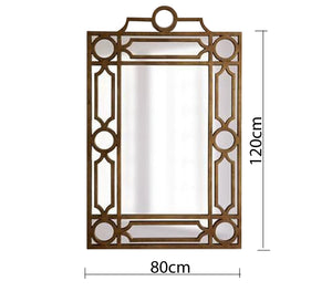 A rectangular mirror with a frame decorated with hollow circles